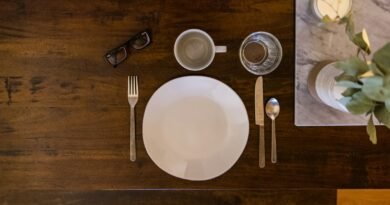 white ceramic plate on brown wooden table