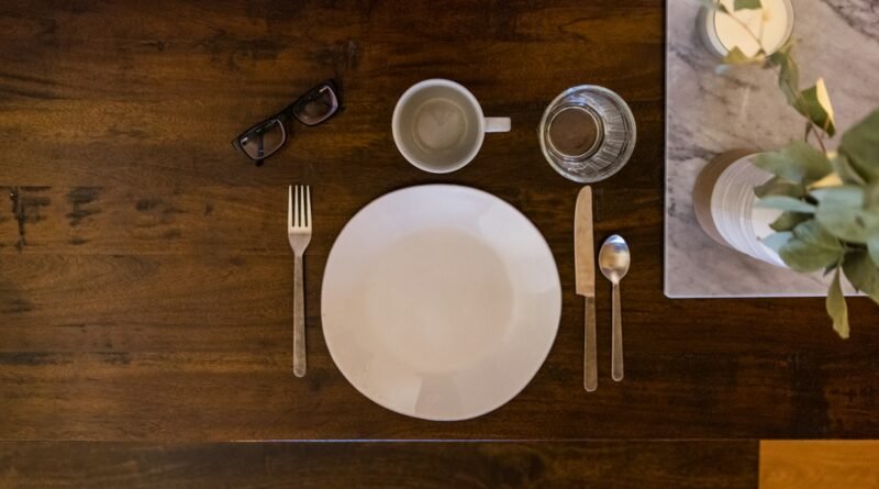 white ceramic plate on brown wooden table