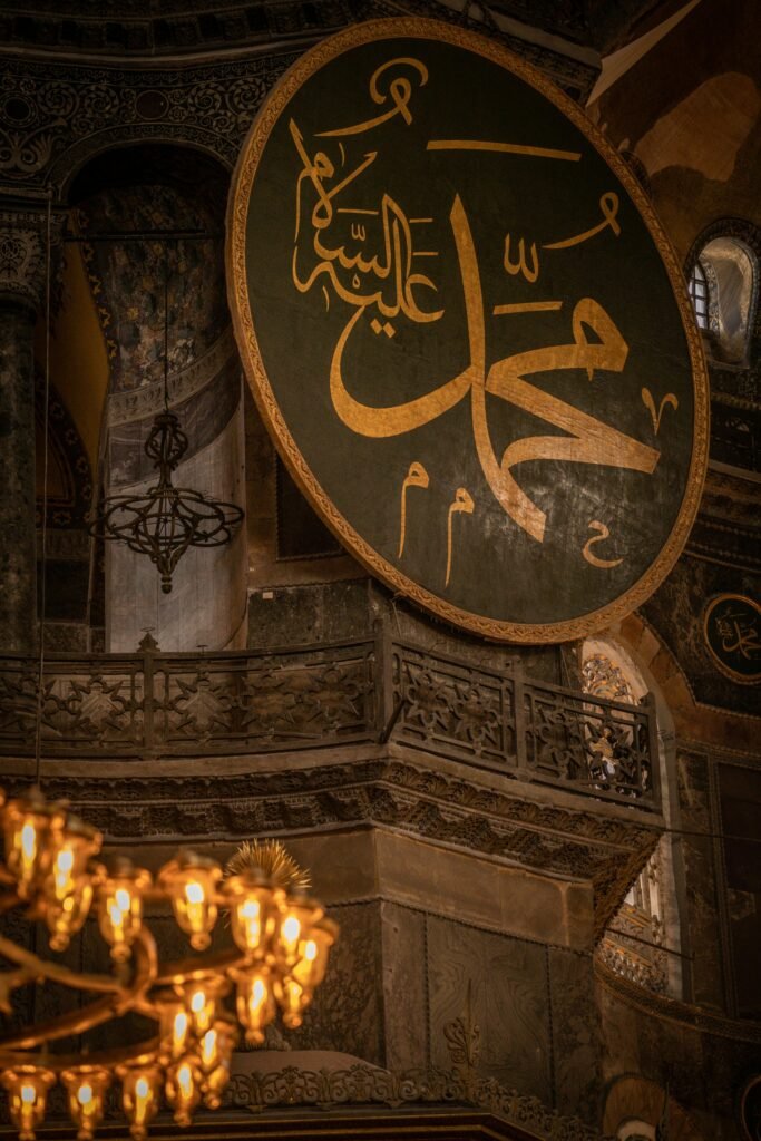 Atmospheric interior shot of Hagia Sophia, highlighting intricate Arabic calligraphy and design.
