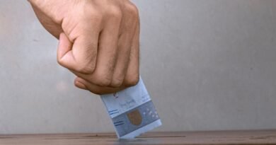 person holding white and blue soft tube