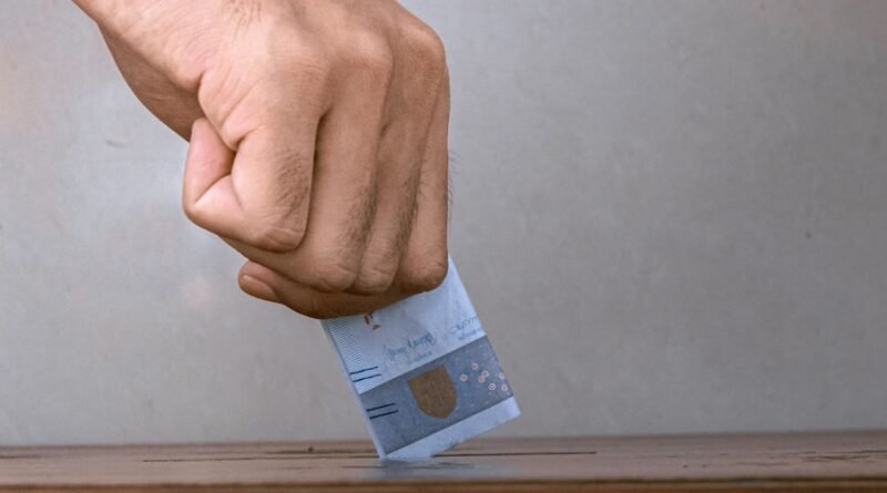 person holding white and blue soft tube