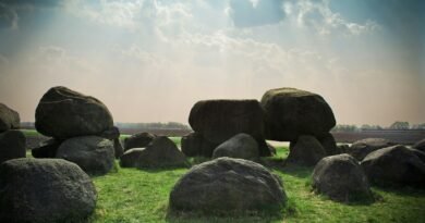stone formation at the green grass field