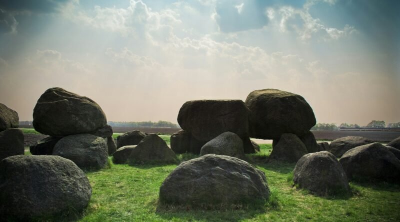 stone formation at the green grass field